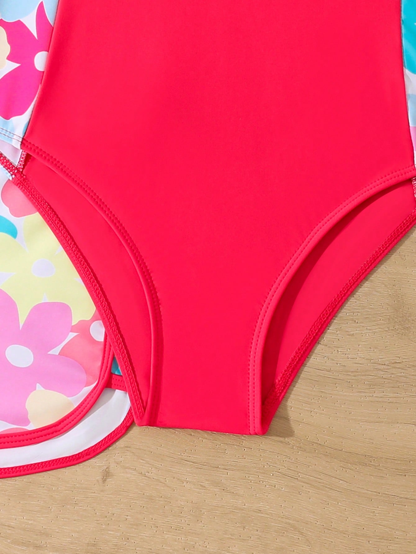 Tween girls 2-piece swimsuit set in black with full floral and plant print, featuring a sleeveless scoop-neck swim top and matching shorts-style bottoms.