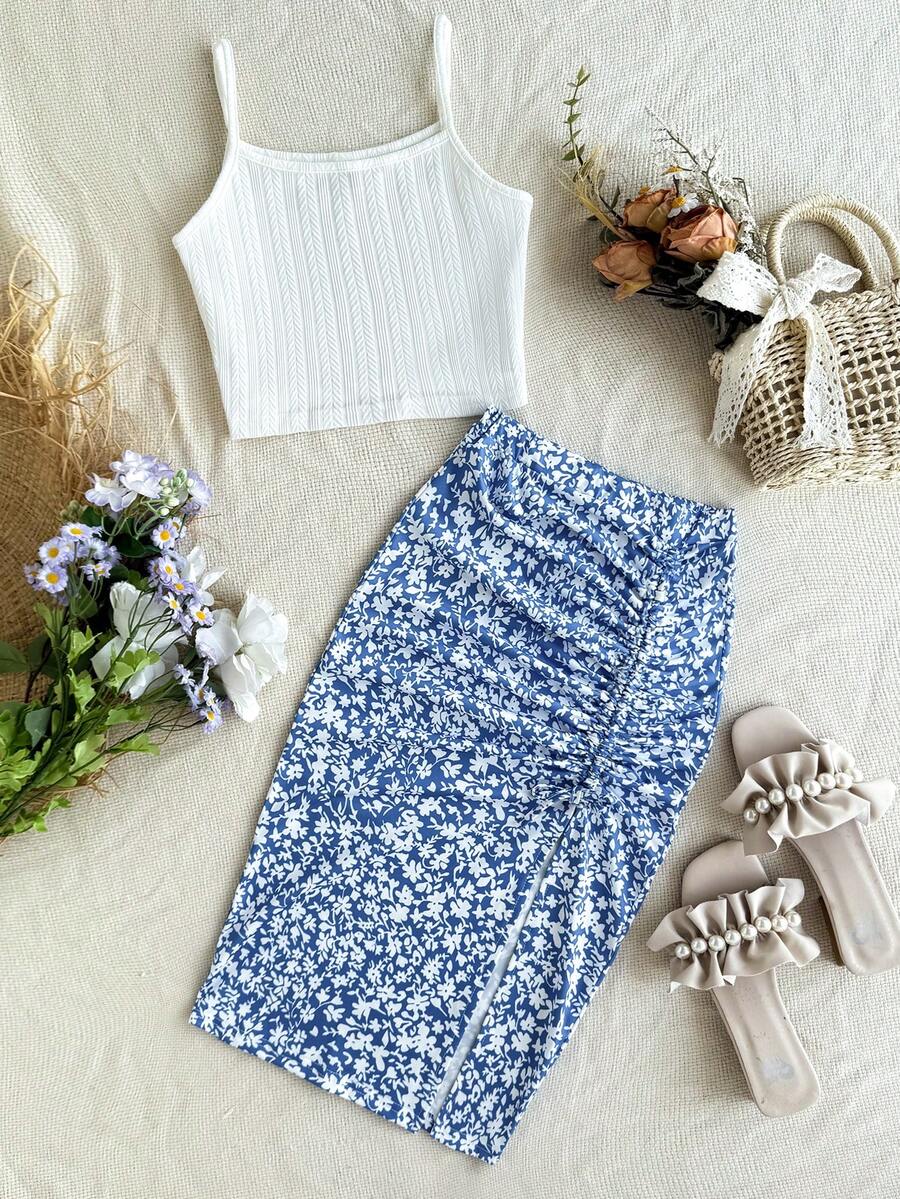Tween girl wearing a 2-piece set featuring a black rib-knit spaghetti strap camisole top and a ruched leopard print midi skirt.
