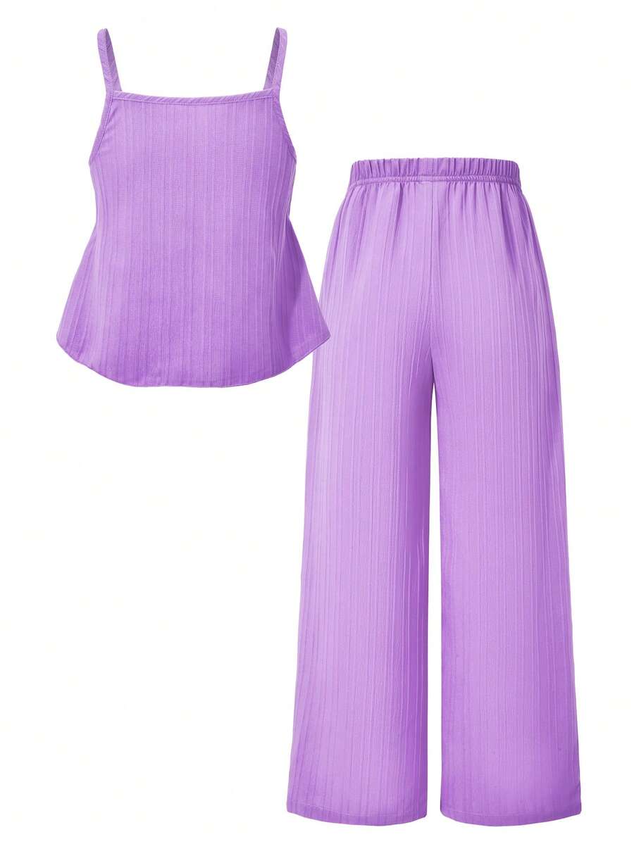 Tween girl wearing an apricot 2-piece outfit set featuring a shirred spaghetti strap short cami top and matching wide-leg long pants.