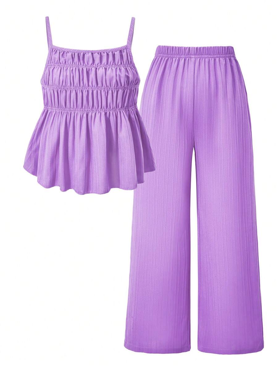 Tween girl wearing an apricot 2-piece outfit set featuring a shirred spaghetti strap short cami top and matching wide-leg long pants.