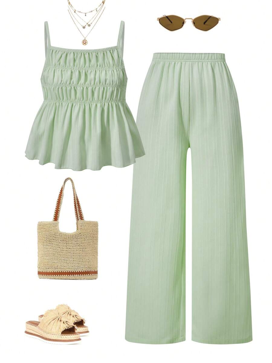 Tween girl wearing an apricot 2-piece outfit set featuring a shirred spaghetti strap short cami top and matching wide-leg long pants.