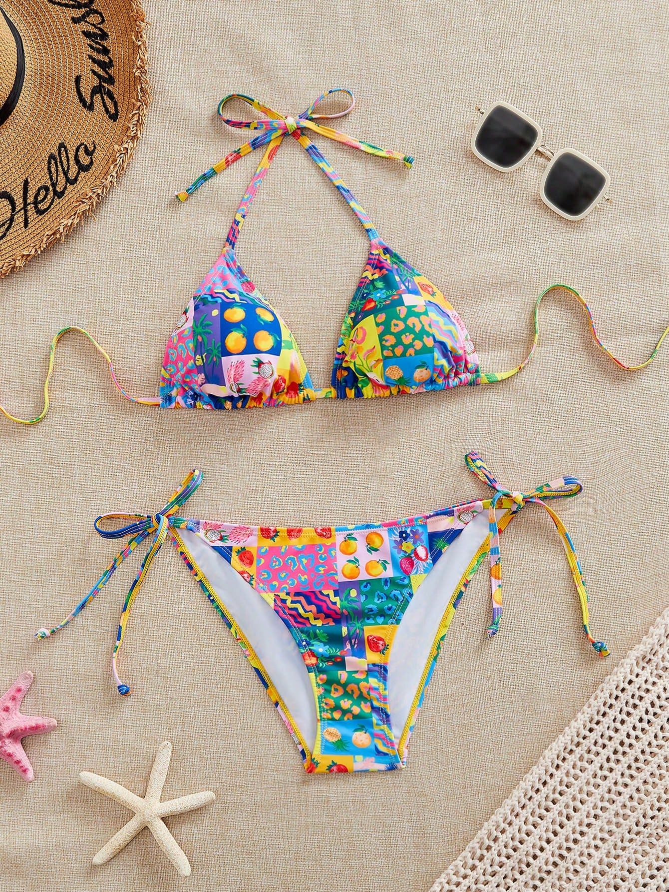 Women's black and white zebra print two-piece bikini set featuring a high waist tie-side bottom and a backless halter top with removable padding.