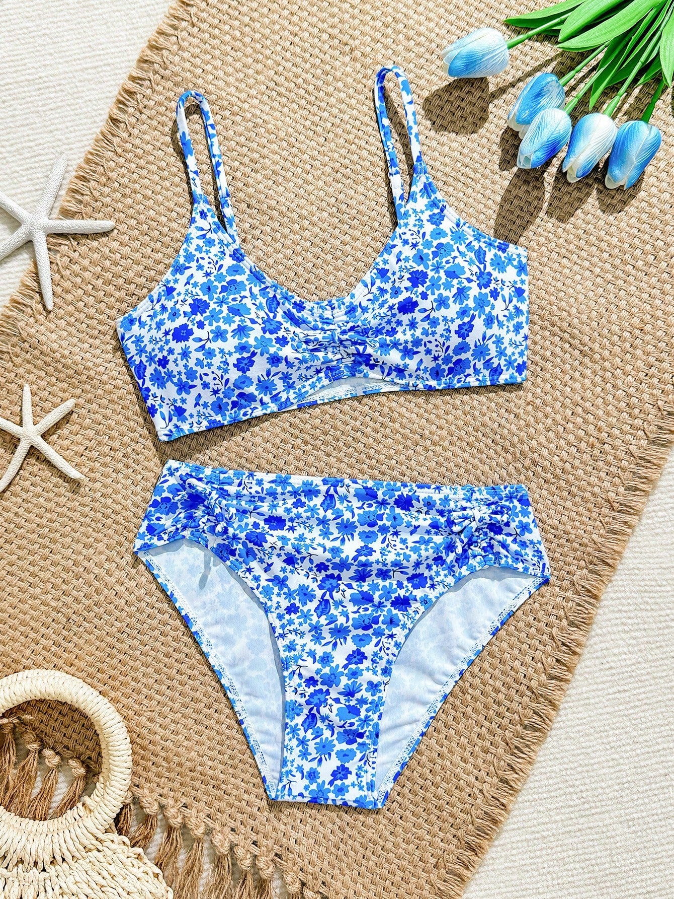 Tween girls 2-piece ditsy floral bikini set featuring a spaghetti strap top with center string detail and matching bottoms with side strings, designed for swimming, vacation, and summer wear.