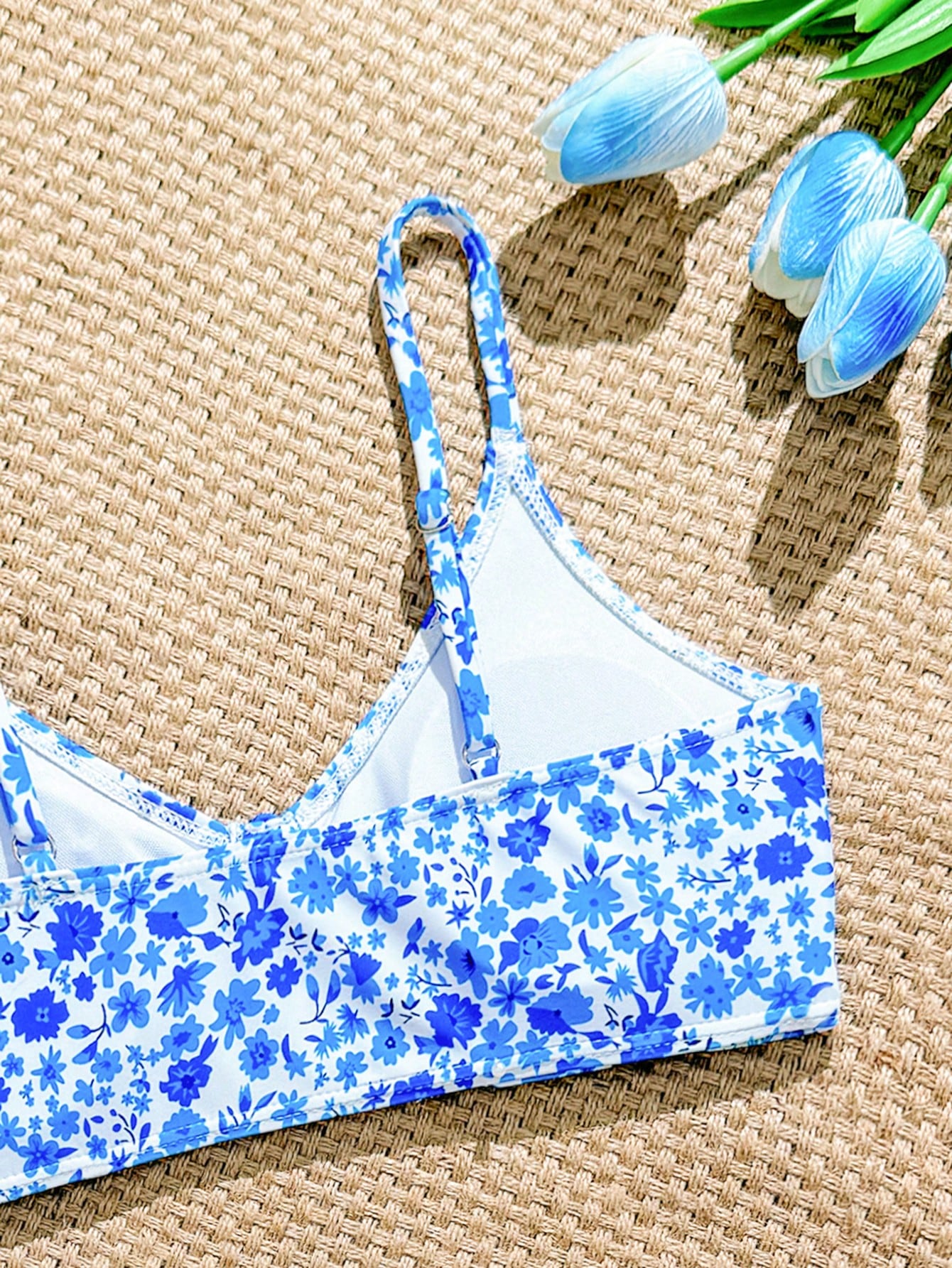Tween girls 2-piece ditsy floral bikini set featuring a spaghetti strap top with center string detail and matching bottoms with side strings, designed for swimming, vacation, and summer wear.