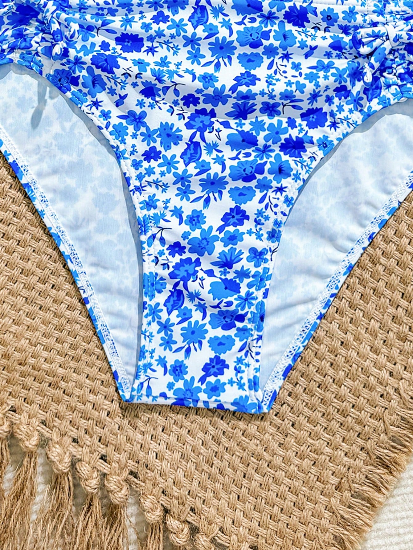 Tween girls 2-piece ditsy floral bikini set featuring a spaghetti strap top with center string detail and matching bottoms with side strings, designed for swimming, vacation, and summer wear.