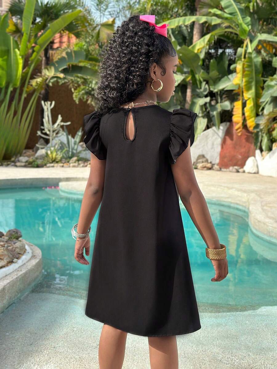 Tween girls sleeveless tropical floral mini dress in black with round neck and ruffle hem detail