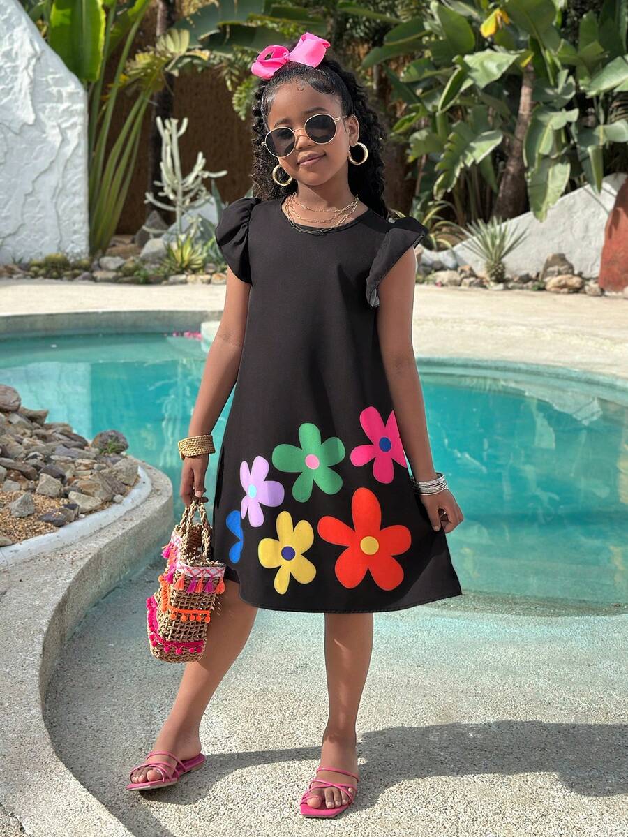 Tween girls sleeveless tropical floral mini dress in black with round neck and ruffle hem detail