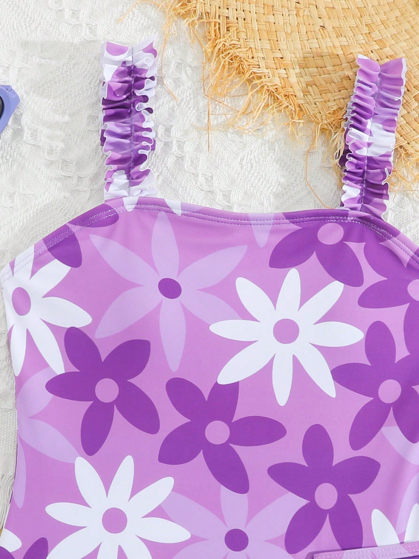 Blue tween girls one-piece swimsuit with tropical plant print, spaghetti straps, ruffle detail, and skirt-style mid-waist bottom for beach and pool wear.