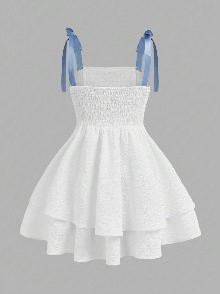 Tween girls apricot tiered cami dress with spaghetti straps, high waist, and slim fit layered hem.