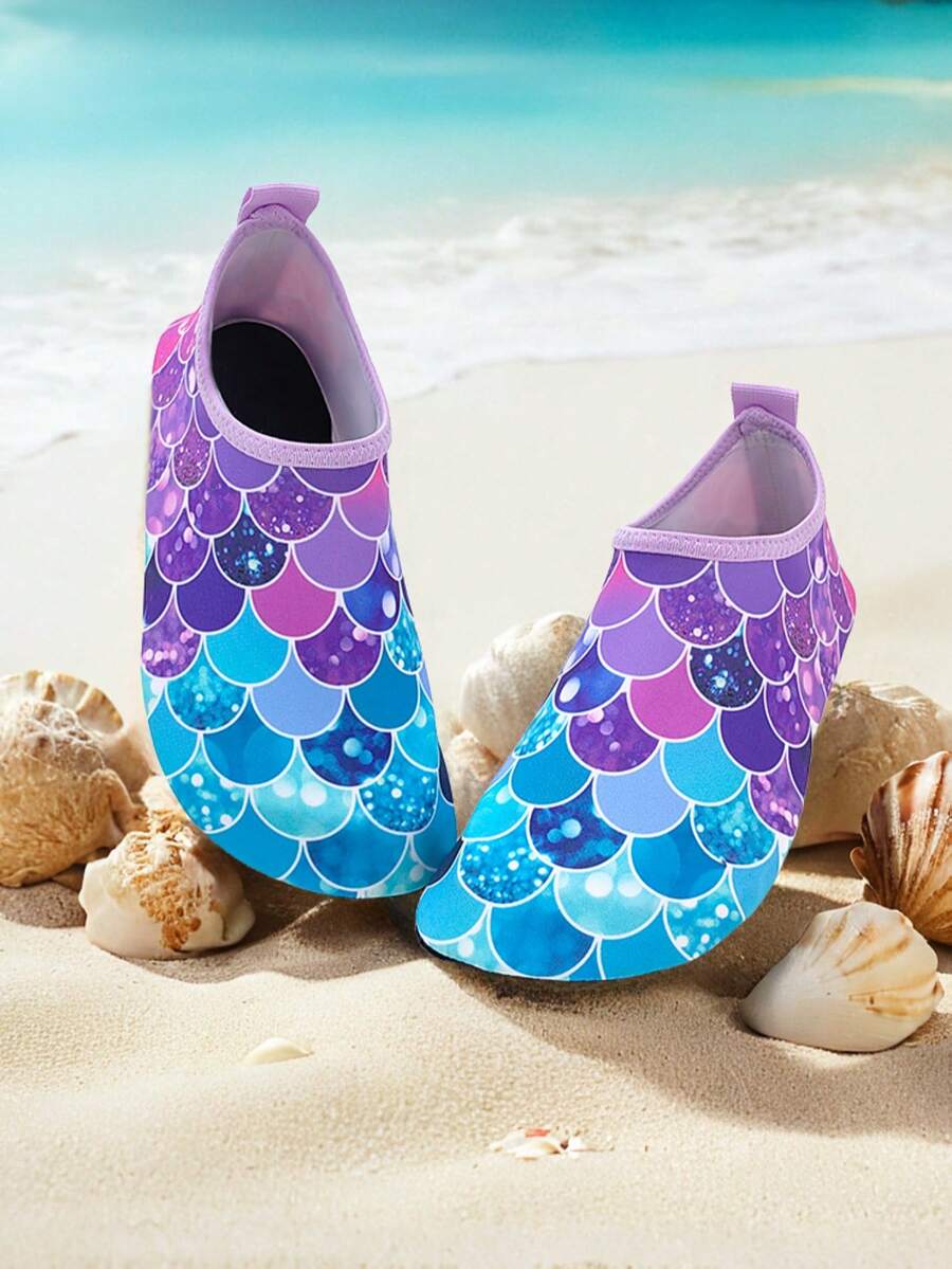 Girls purple slip-on water sandals with a textured fish scale pattern, breathable fabric upper, and flexible TPR sole.