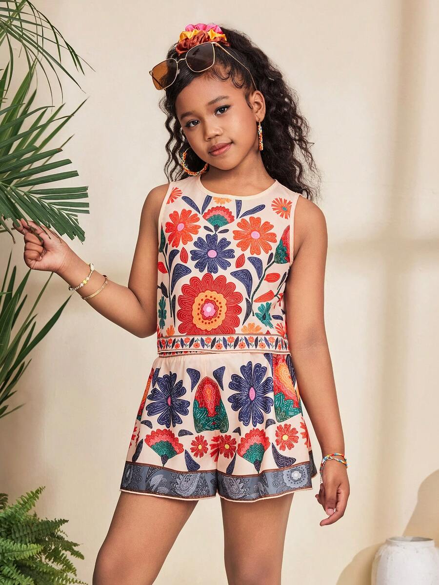 Tween girl wearing a tropical floral print two-piece vacation set featuring a sleeveless round neck tank top with button details and matching shorts.