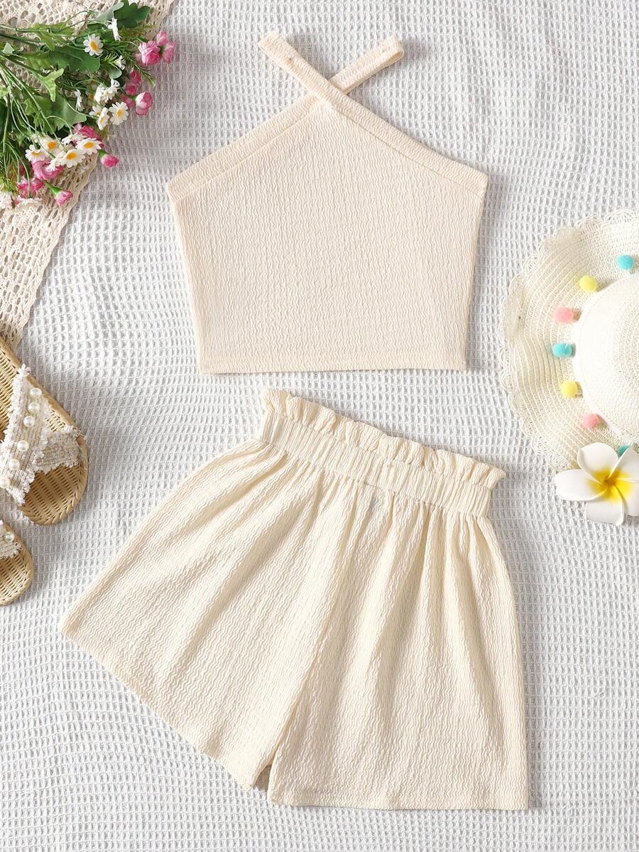 Tween girl 2-piece casual outfit set featuring a solid beige knit halter sleeveless top with belted detail and matching shorts.