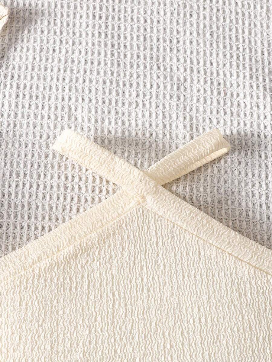 Tween girl 2-piece casual outfit set featuring a solid beige knit halter sleeveless top with belted detail and matching shorts.