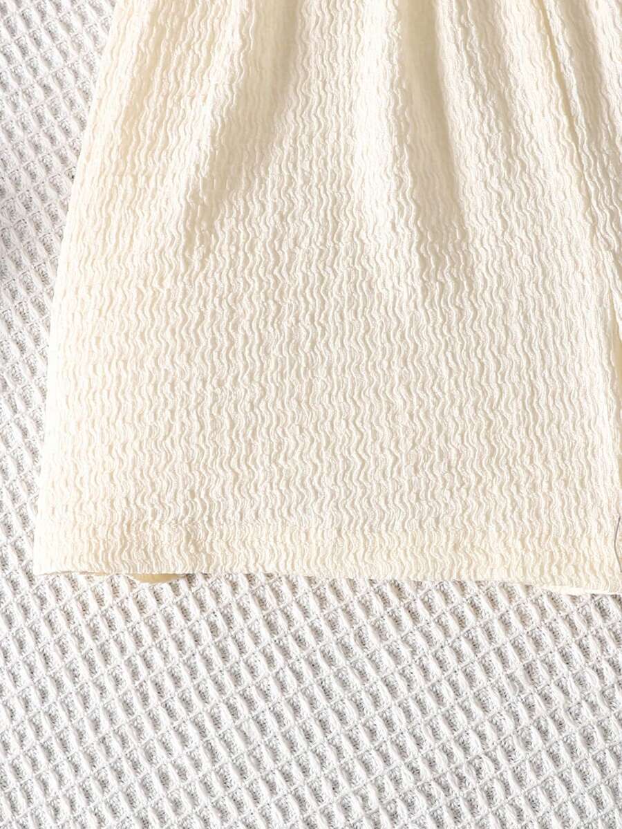 Tween girl 2-piece casual outfit set featuring a solid beige knit halter sleeveless top with belted detail and matching shorts.