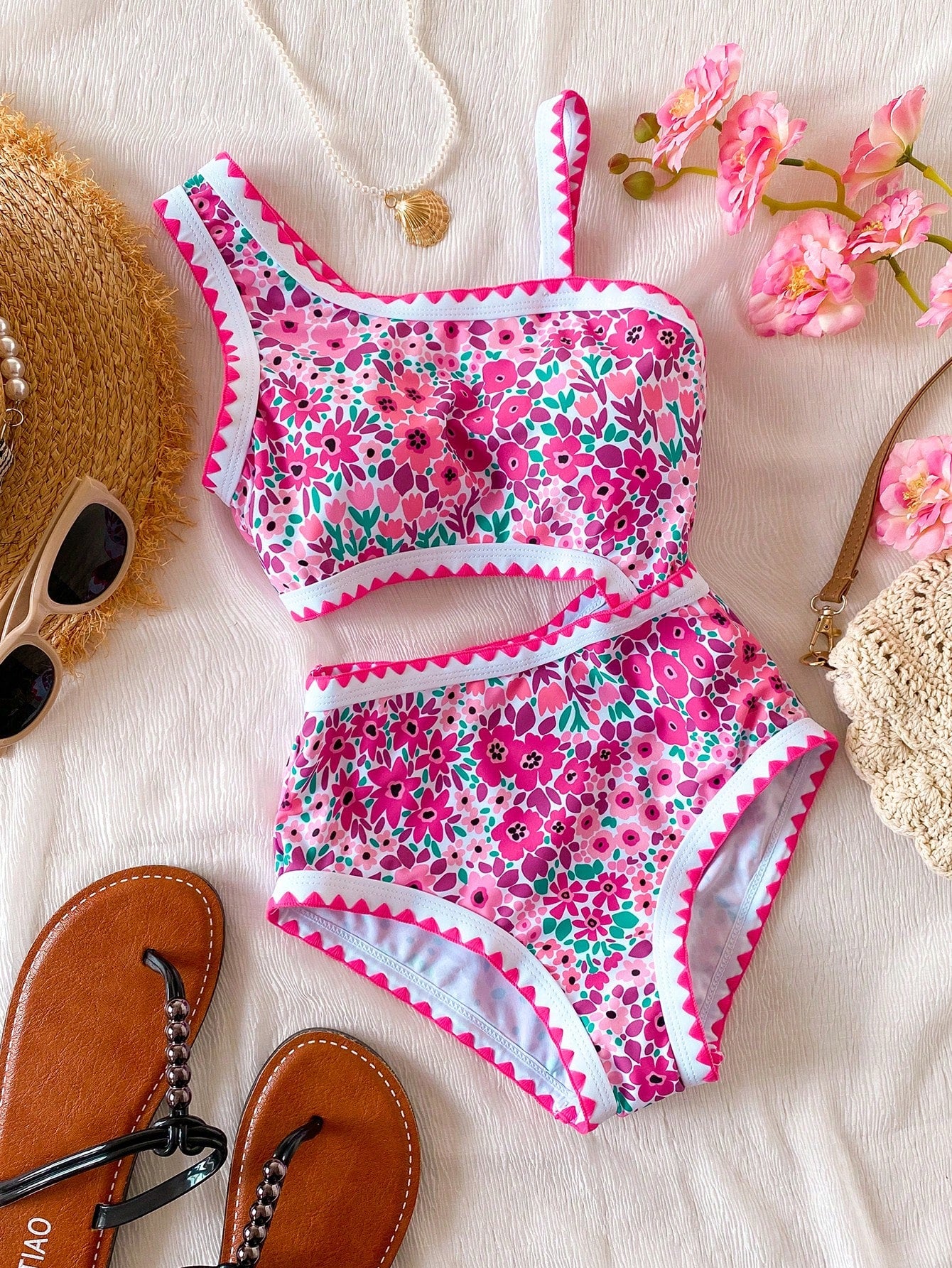Tween girls one-piece swimsuit featuring an asymmetric neckline, pendant decor, plain design, wireless bra, high-cut bottom, and medium-stretch fabric.