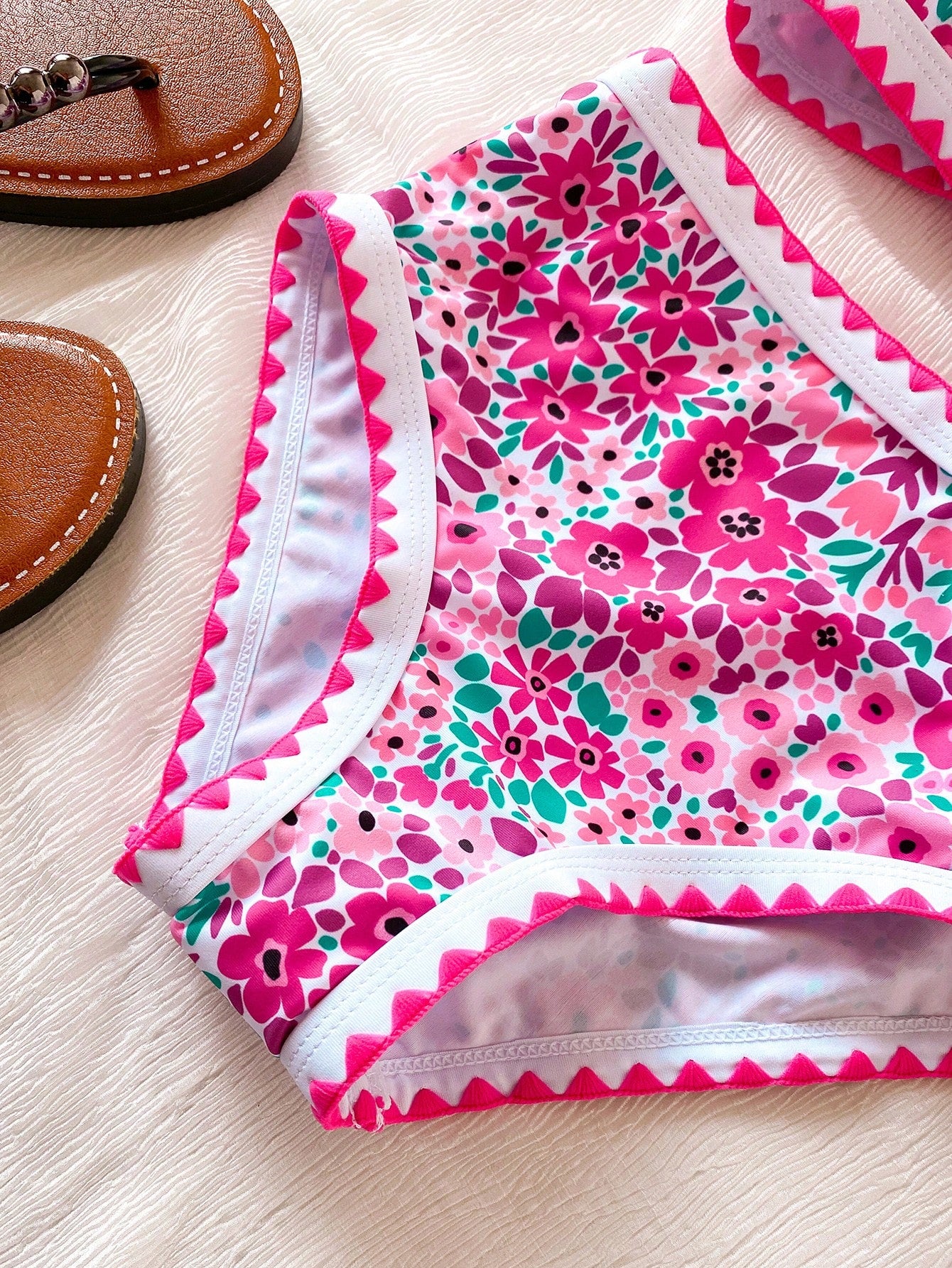 Tween girls one-piece swimsuit featuring an asymmetric neckline, pendant decor, plain design, wireless bra, high-cut bottom, and medium-stretch fabric.