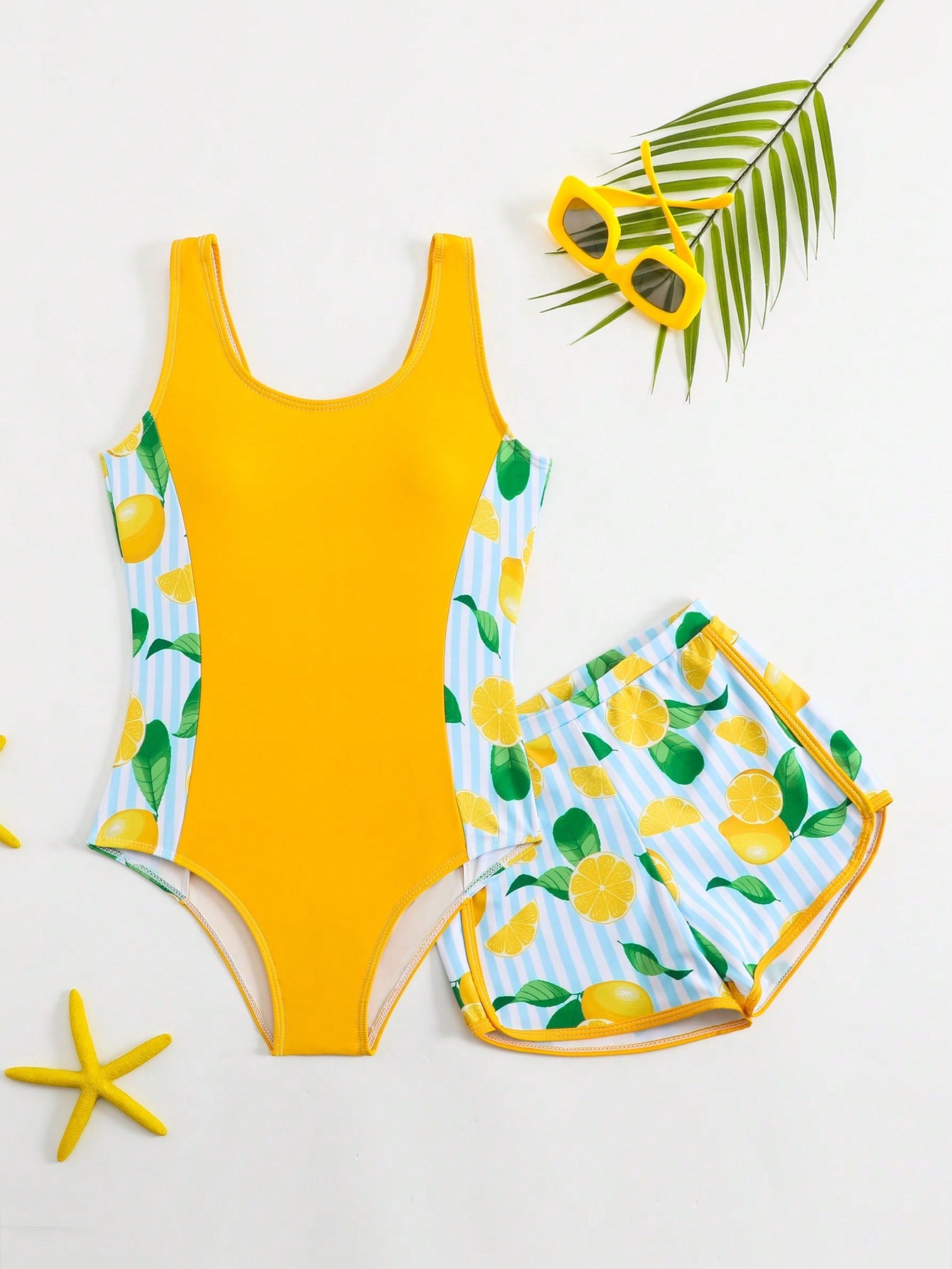 Tween girls 2-piece swimsuit set with a printed one-piece featuring ruffle trim, scoop neckline, cut-out detail, and matching shorts bottom.
