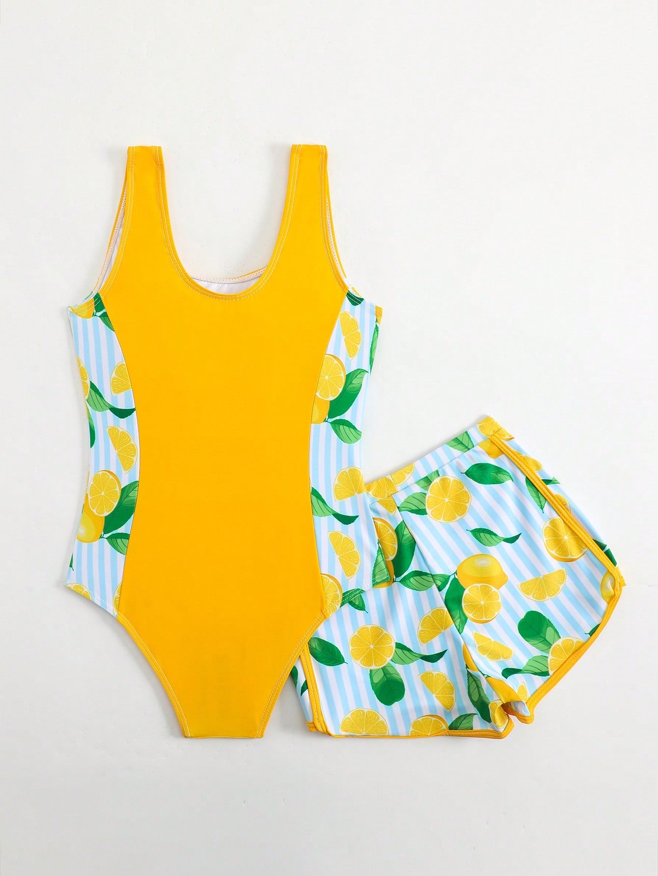 Tween girls 2-piece swimsuit set with a printed one-piece featuring ruffle trim, scoop neckline, cut-out detail, and matching shorts bottom.