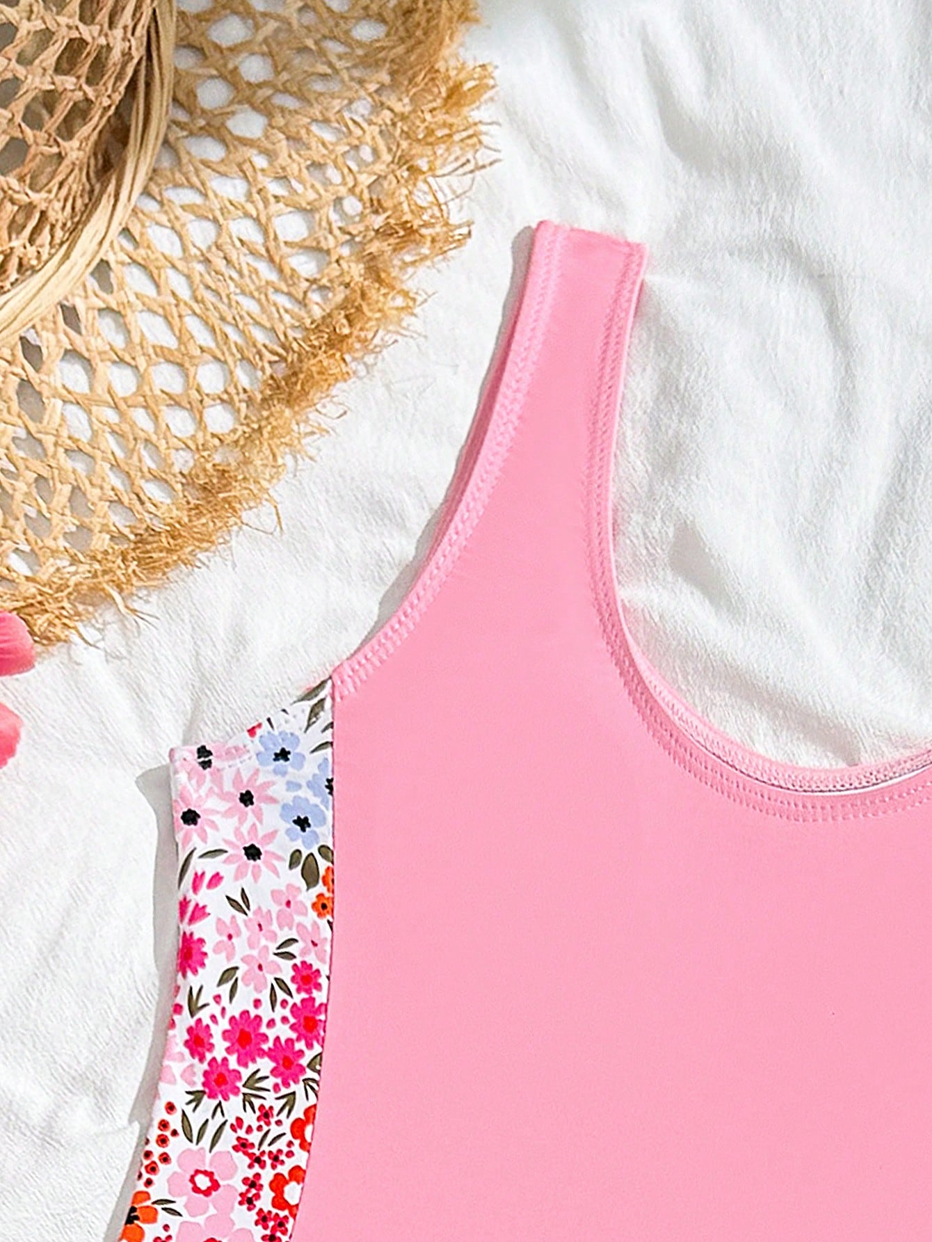 Tween girls 2-piece swimsuit set in black with full floral and plant print, featuring a sleeveless scoop-neck swim top and matching shorts-style bottoms.