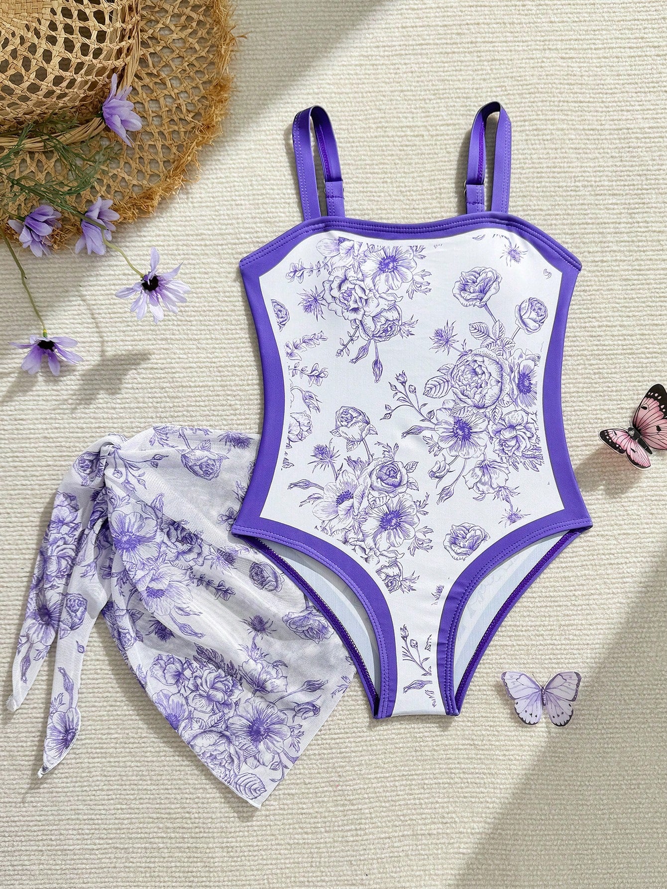 Tween girl multicolor floral one-piece swimsuit with asymmetrical spaghetti straps and knotted side swim skirt