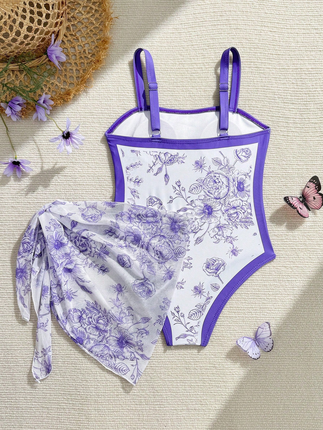 Tween girl multicolor floral one-piece swimsuit with asymmetrical spaghetti straps and knotted side swim skirt