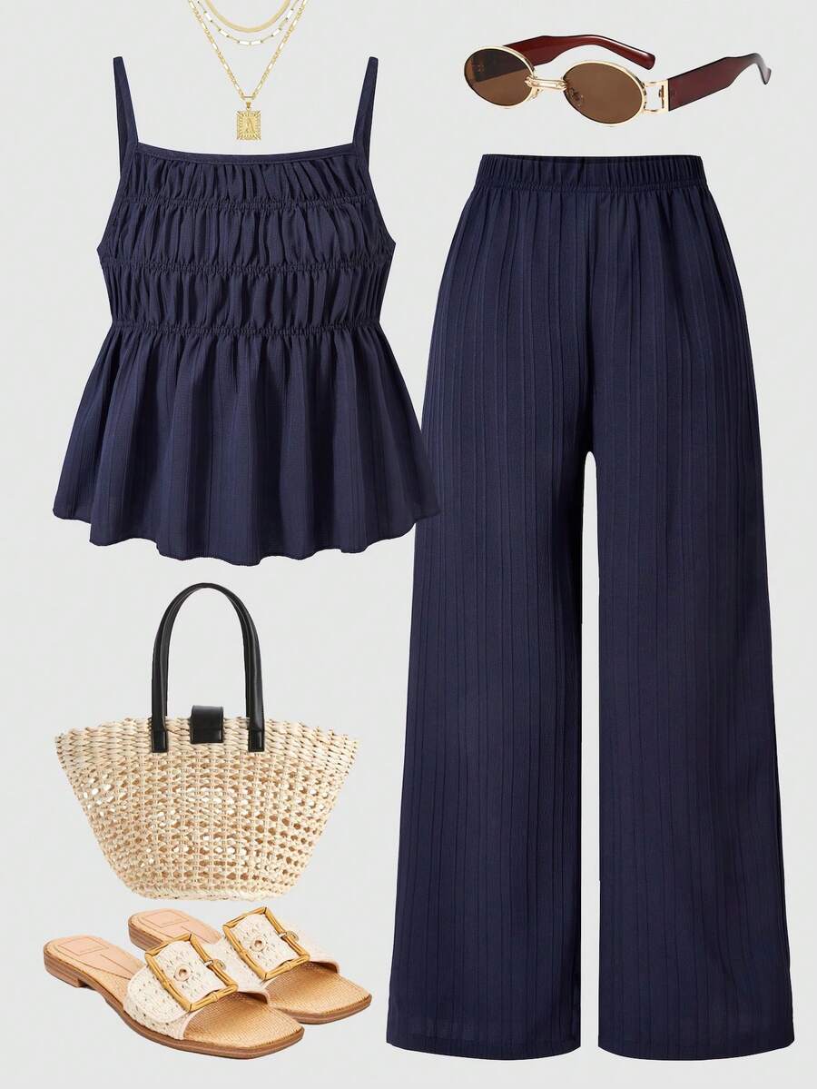 Tween girl wearing an apricot 2-piece outfit set featuring a shirred spaghetti strap short cami top and matching wide-leg long pants.