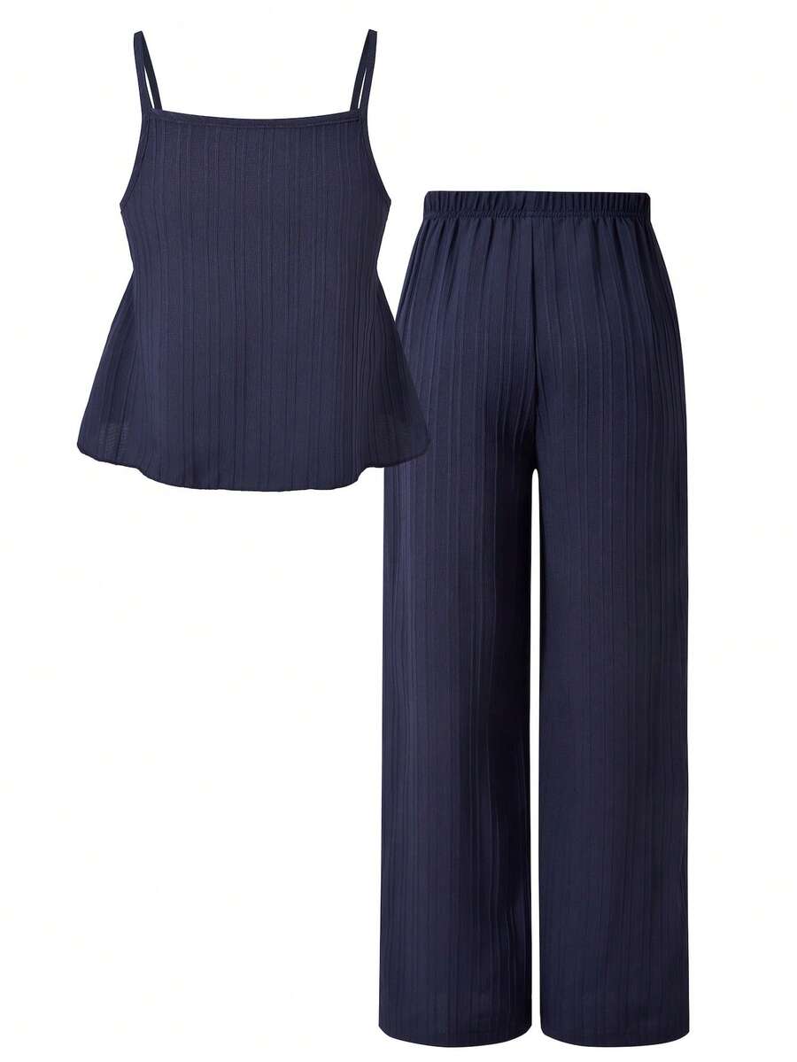 Tween girl wearing an apricot 2-piece outfit set featuring a shirred spaghetti strap short cami top and matching wide-leg long pants.