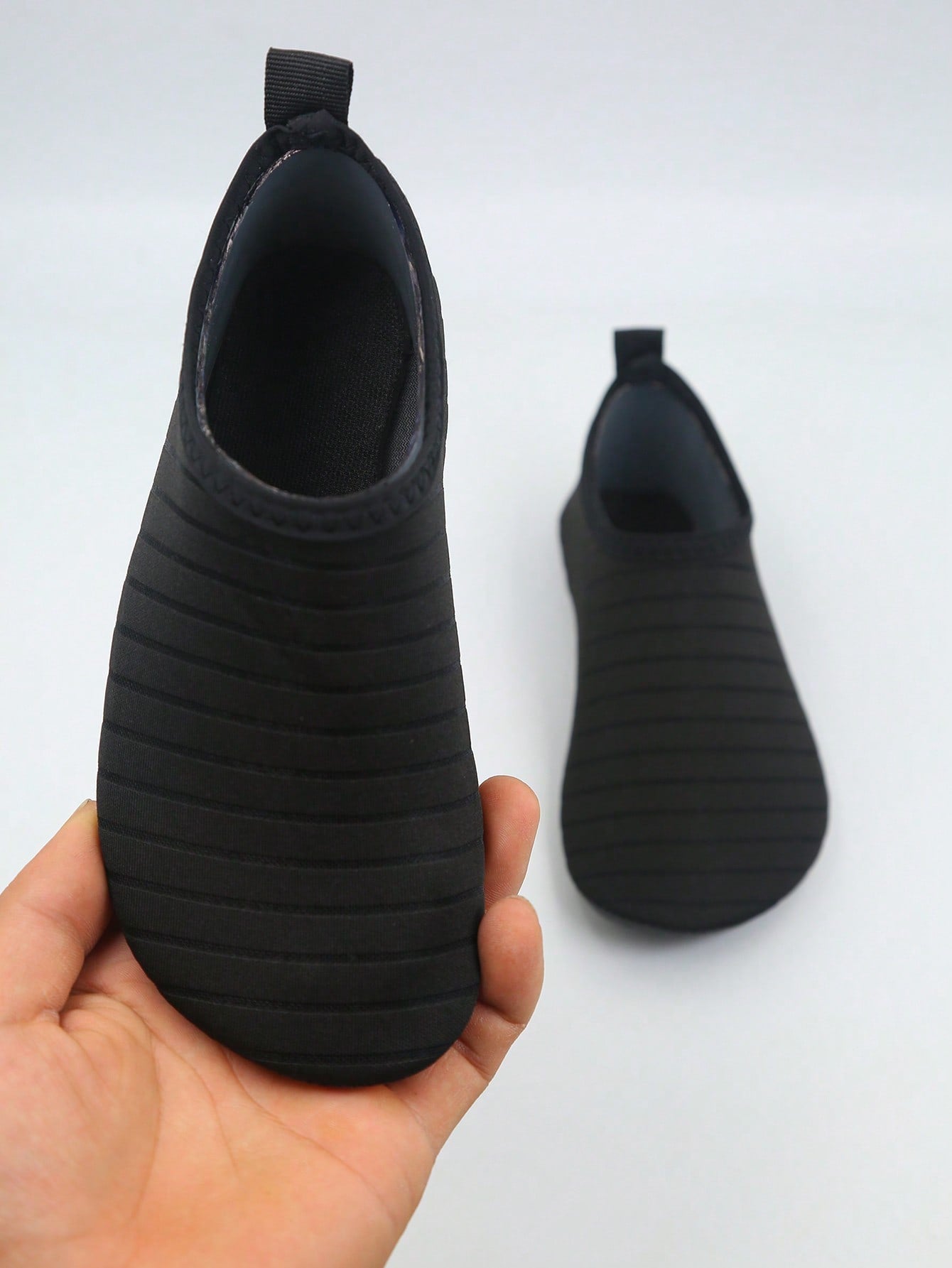 Kids slip-on aqua socks featuring geometric pattern, breathable Lycra upper, and non-slip TPR outsole for beach and water activities.
