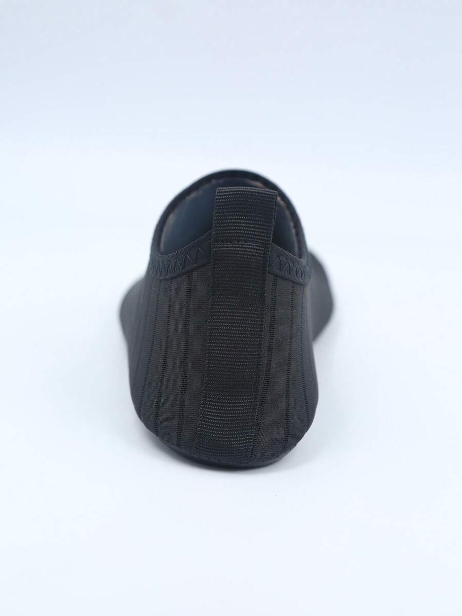 Kids slip-on aqua socks featuring geometric pattern, breathable Lycra upper, and non-slip TPR outsole for beach and water activities.