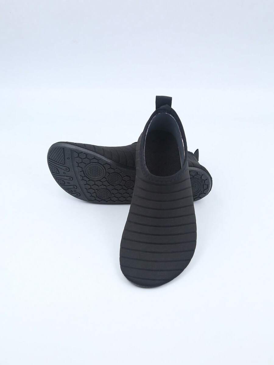 Kids slip-on aqua socks featuring geometric pattern, breathable Lycra upper, and non-slip TPR outsole for beach and water activities.