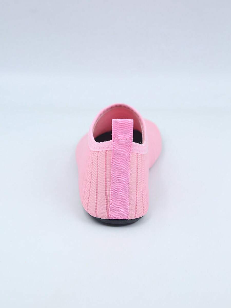 Kids slip-on aqua socks featuring geometric pattern, breathable Lycra upper, and non-slip TPR outsole for beach and water activities.