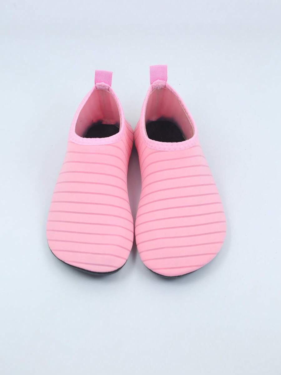 Kids slip-on aqua socks featuring geometric pattern, breathable Lycra upper, and non-slip TPR outsole for beach and water activities.