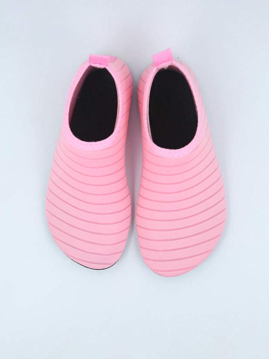 Kids slip-on aqua socks featuring geometric pattern, breathable Lycra upper, and non-slip TPR outsole for beach and water activities.