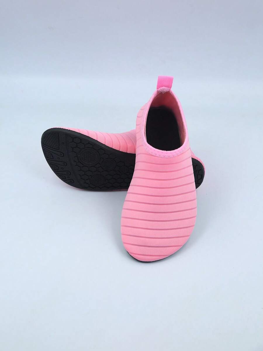 Kids slip-on aqua socks featuring geometric pattern, breathable Lycra upper, and non-slip TPR outsole for beach and water activities.