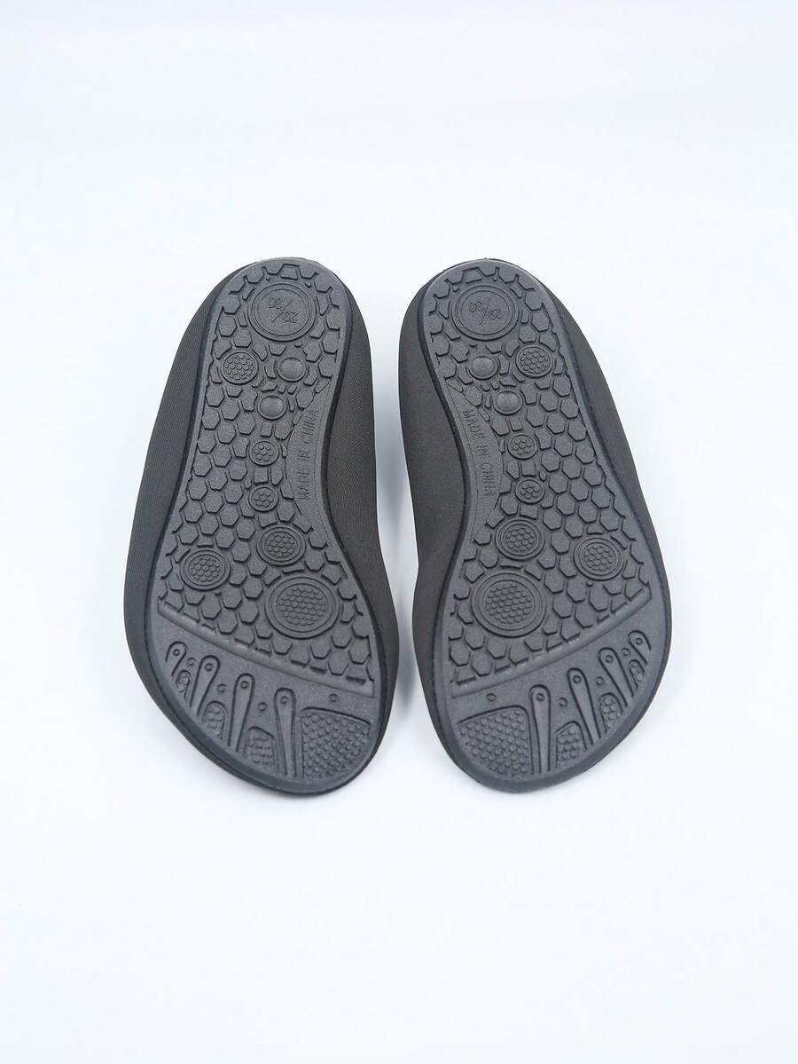 Kids slip-on aqua socks featuring geometric pattern, breathable Lycra upper, and non-slip TPR outsole for beach and water activities.