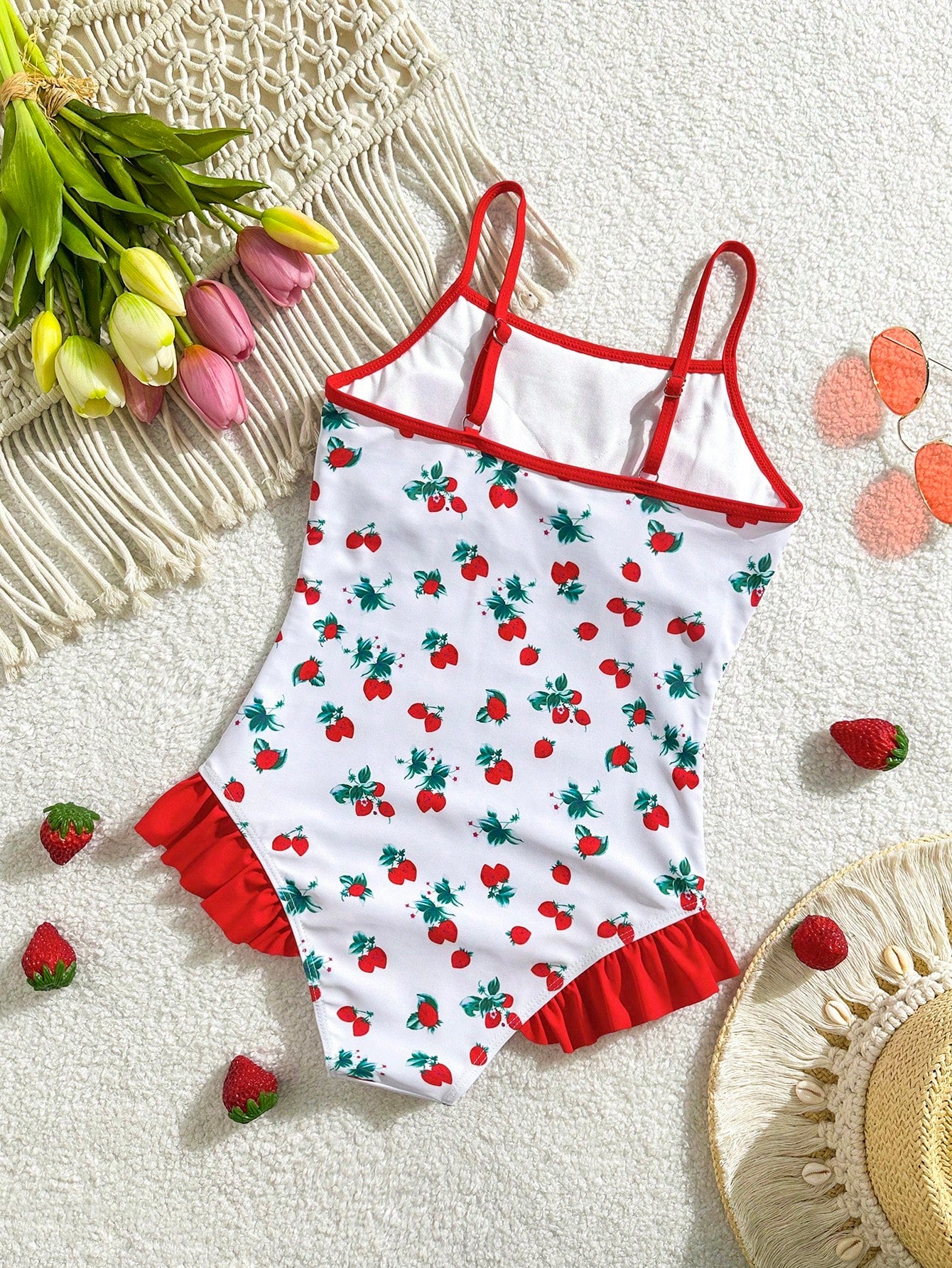 Tween girl plaid all-over print one-piece swimsuit with ruffle detail, spaghetti straps, fitted shape, and multicolor patchwork style for beach or pool wear.