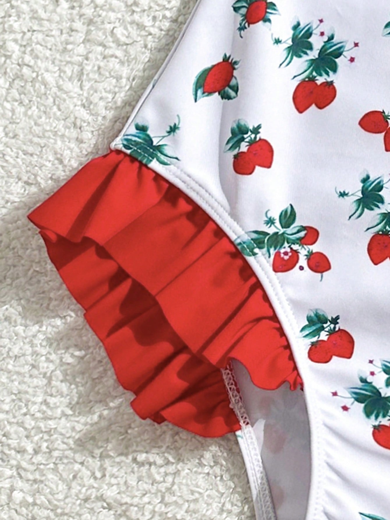 Tween girl plaid all-over print one-piece swimsuit with ruffle detail, spaghetti straps, fitted shape, and multicolor patchwork style for beach or pool wear.