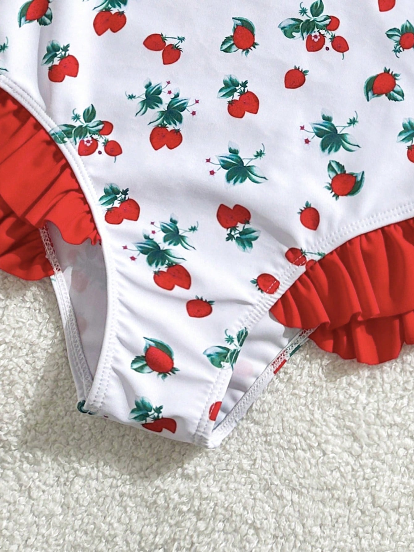 Tween girl plaid all-over print one-piece swimsuit with ruffle detail, spaghetti straps, fitted shape, and multicolor patchwork style for beach or pool wear.