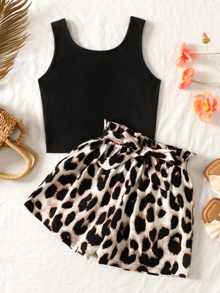Tween girl wearing a casual 2-piece set featuring a black rib-knit scoop neck tank top and leopard print paperbag waist shorts with a matching belt.