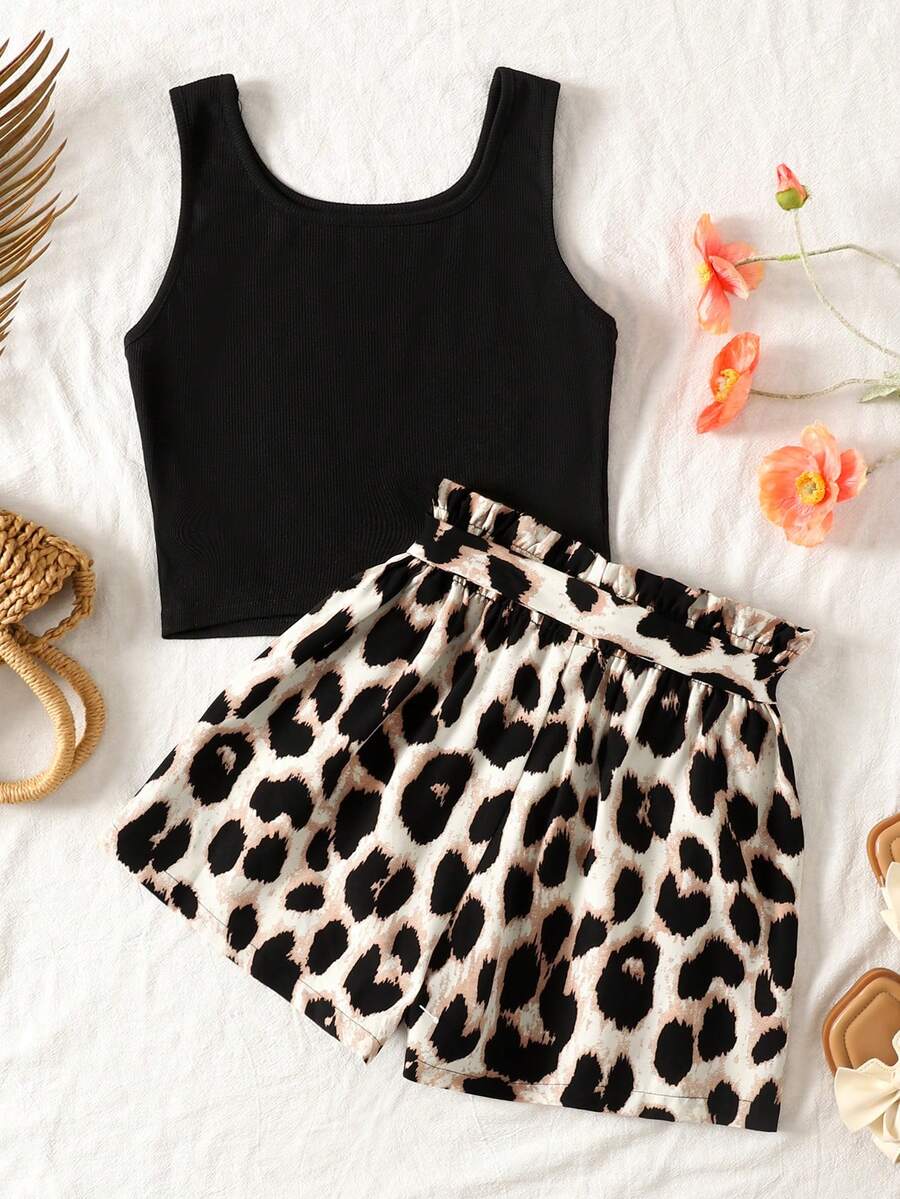 Tween girl wearing a casual 2-piece set featuring a black rib-knit scoop neck tank top and leopard print paperbag waist shorts with a matching belt.
