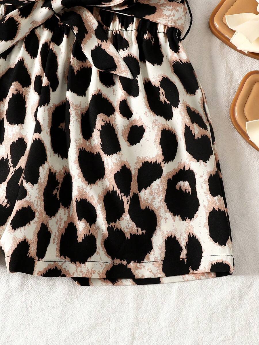 Tween girl wearing a casual 2-piece set featuring a black rib-knit scoop neck tank top and leopard print paperbag waist shorts with a matching belt.