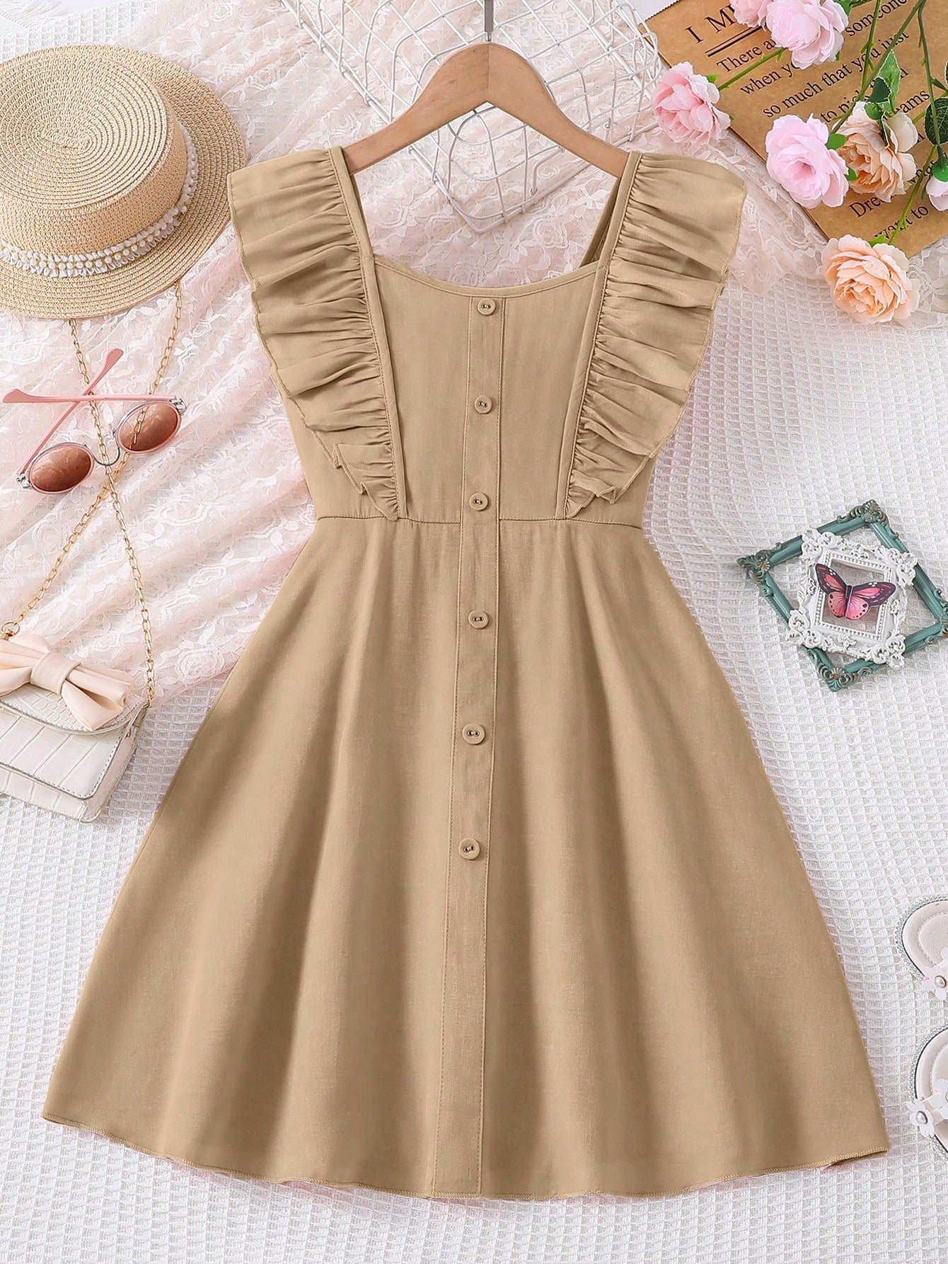 Vintaside tween girls sleeveless blue A-line dress featuring ruffle trim, square neckline, button front, and shirred back.