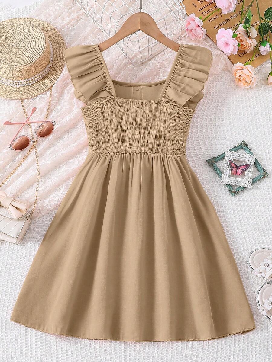 Vintaside tween girls sleeveless blue A-line dress featuring ruffle trim, square neckline, button front, and shirred back.