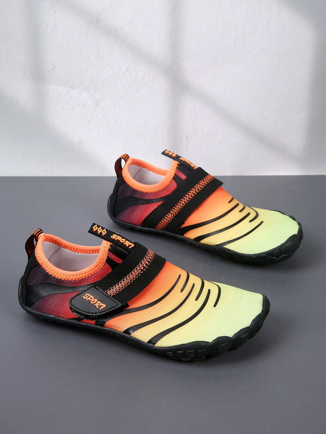 Boys orange lightweight sports water shoes featuring breathable mesh upper, hook loop closure, colorblock design, and non-slip rubber outsole.