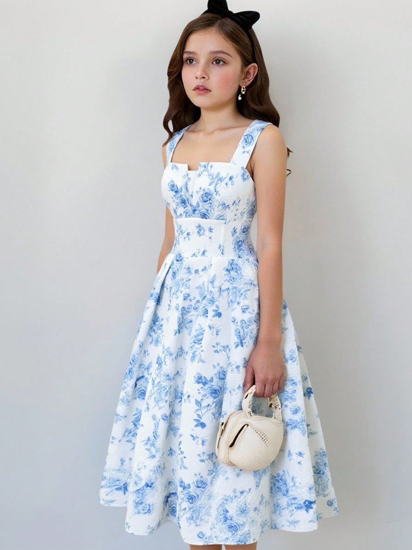 Tween girl apricot floral print midi dress with ruffle shoulder straps, shirred detail, and high waist A-line fit.