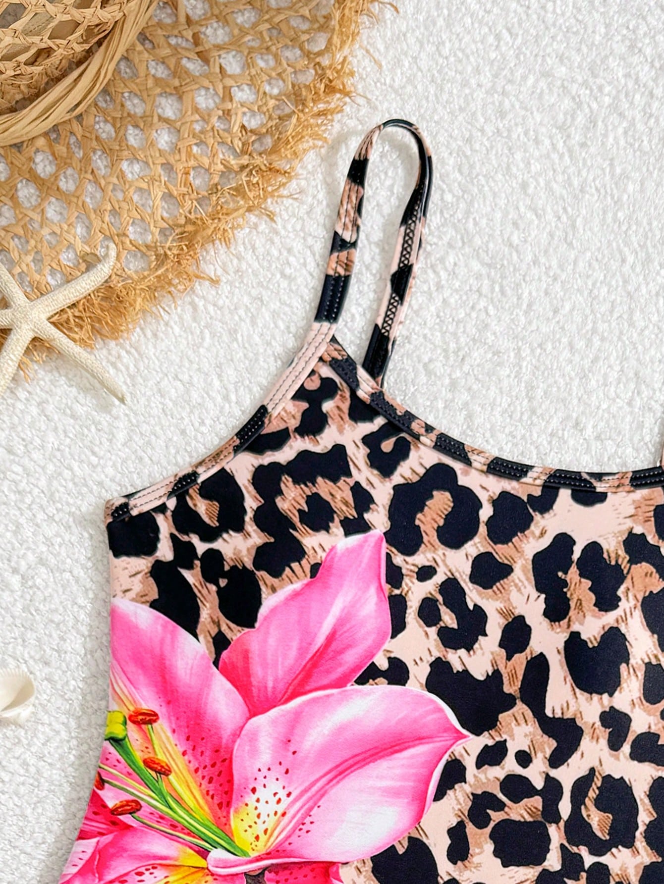 Multicolor girls' one-piece swimsuit with a bowknot pattern and spaghetti straps, shown with a black-trim triangle sarong in a 2-piece beachwear set.
