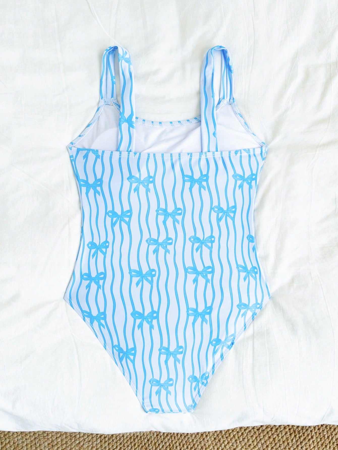 Tween girls one-piece swimsuit in mauve purple with all-over print, spaghetti straps, short length, and vacation swimwear style for beach, pool, and summer swimming.