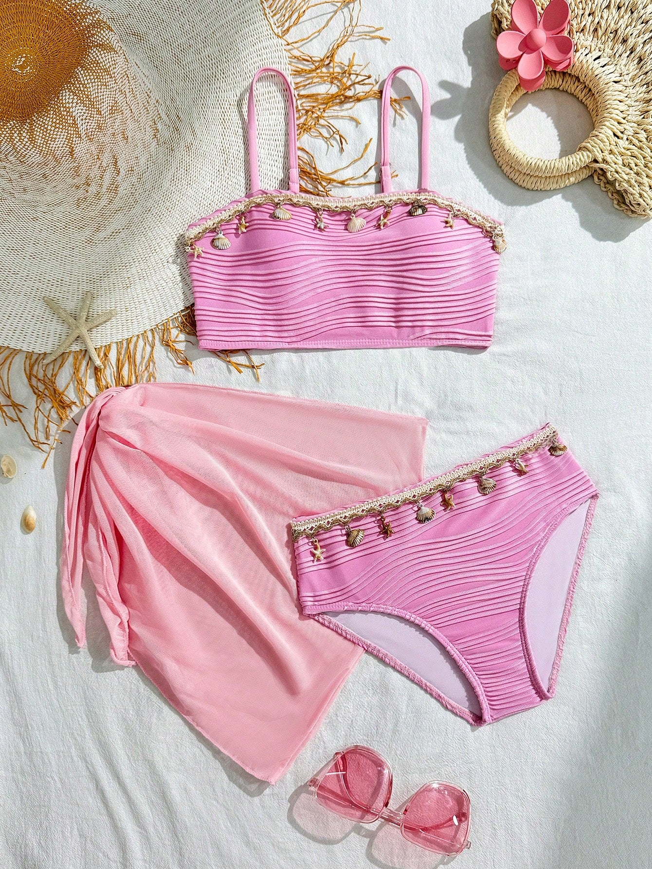 Tween girls bikini set with shell and starfish woven band details, spaghetti strap sleeveless top, and mid-waist skirt-style bottom in blue.