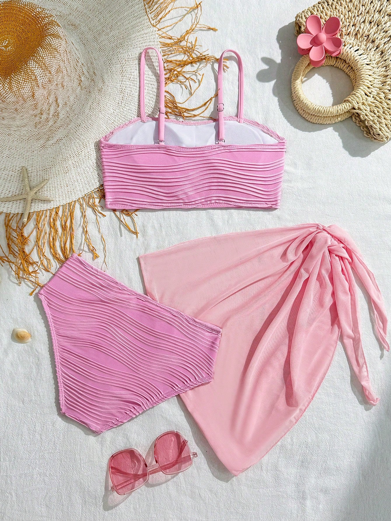 Tween girls bikini set with shell and starfish woven band details, spaghetti strap sleeveless top, and mid-waist skirt-style bottom in blue.