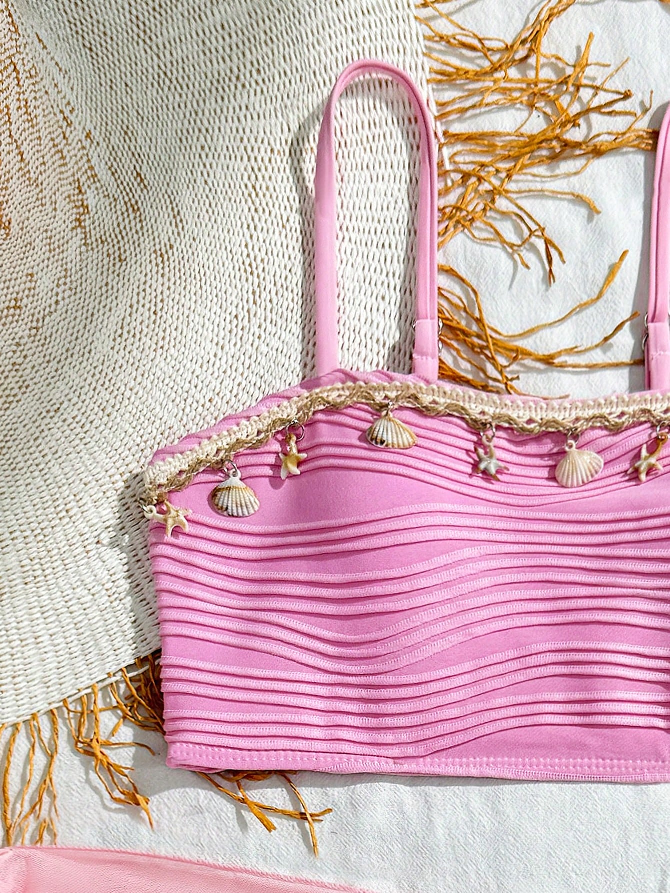 Tween girls bikini set with shell and starfish woven band details, spaghetti strap sleeveless top, and mid-waist skirt-style bottom in blue.